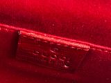 a close up of a red purse with a gold clasp