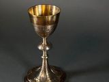 an antique silver goblet sitting on top of a table