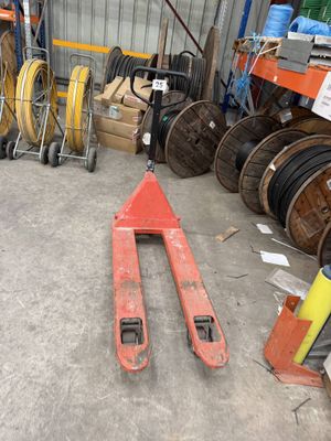 a forklift in the middle of a warehouse filled with lots of different types of equipment