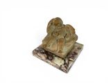 statue of a man and a woman on a marble base