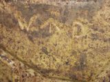 a close up of a piece of metal with writing on it