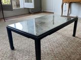 a table with a glass top in the middle of a living room