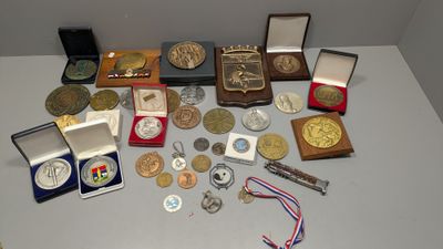 a lot of medals and medals on the table