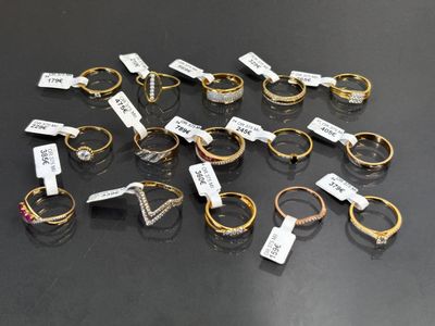 a group of rings with tags on them sitting on top of a table
