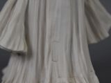 statue of a woman in a white dress holding a white umbrella