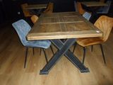 a wooden table and chairs in a room with wood flooring