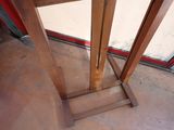a close up of a wooden table with a glass door in the background