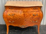 an antique chest of drawers with marble top