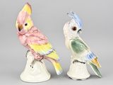 two figurines of birds sitting on top of each other on a table