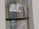 several rolls of fabric wrapped in plastic sitting on top of a table