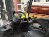 a forklift with a steering sitting in the back of a truck