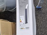 a box of electronic equipment on the ground next to a metal pipe