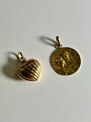 a pair of gold toned earrings with a coin on top