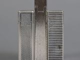 two silver lighters sitting next to each other on a table