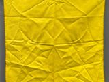 a yellow piece of cloth hanging on a clothes line