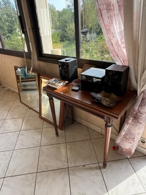 a small table with a printer on it in front of a window