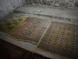 two rugs laid out on the floor in a room