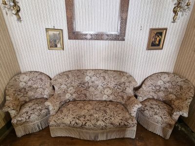a picture of a living room with a couch and two chairs