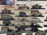 a lot of toy military vehicles on display in a display case