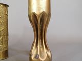 two gold vases sitting next to each other on a table