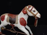 a toy horse that is standing on a black surface