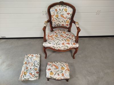 an image of a chair and ottoman in a room