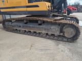 a picture of a yellow and black bulldozer parked in a parking lot