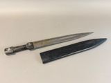 a knife and a comb on a white surface