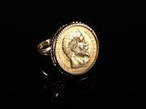 Gros plan sur une bague en or ornée d'une pièce de monnaie