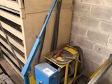 a blue machine that is sitting in the corner of a building
