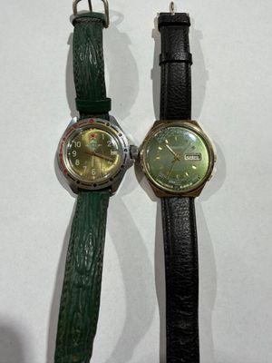 two watches sitting next to each other on a table