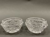 pair of clear glass vases sitting on top of a table