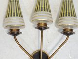 three light wall sconce with gold and white shades on a white background