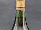bottle of wine with a cork in it sitting on a table