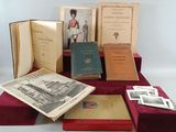 several old books are sitting on a red tablecloth on a white surface
