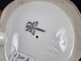 a white porcelain bowl with a black bird on it