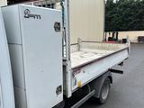 a white truck with a refrigerator in the back of it