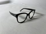 a pair of glasses sitting on a white surface