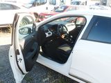 a white car with its door open in a parking lot