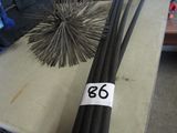 two black sticks sitting on a table with a number 66 on it