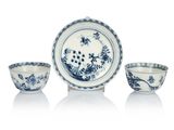 three blue and white bowls and a bowl on a white surface