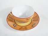 a cup and saucer sitting on a saucer on a table