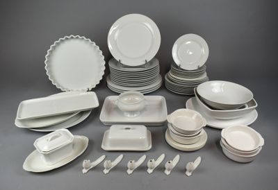a lot of white plates and bowls on the table