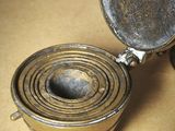 a metal container with a metal lid on a table