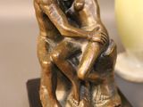a statue of a man and a woman hugging on a table