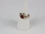 sterling silver ring with a red stone in the middle of it