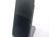 a cell phone that is sitting on top of a stand