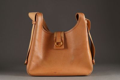 a close up of a brown purse on a gray surface