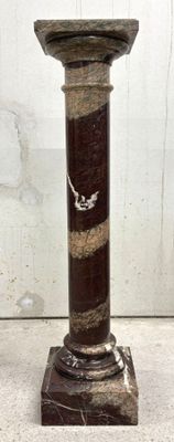 a marble pedestal with a bird on top of it