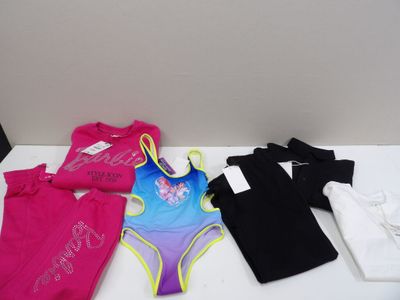 girls swimsuits and t - shirts for sale at a store